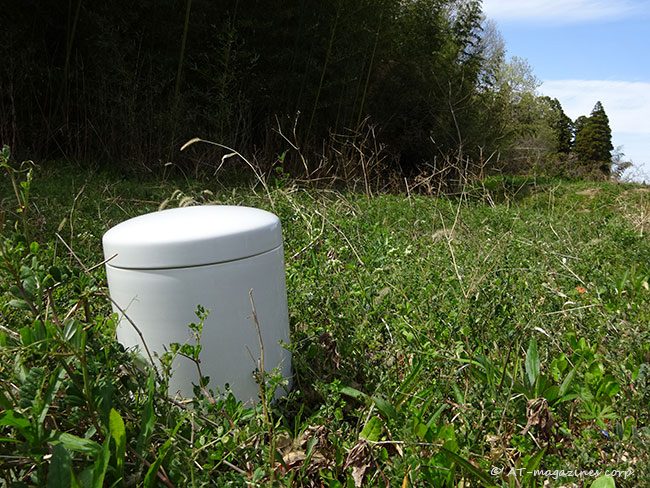 空き地に置かれた骨壺
